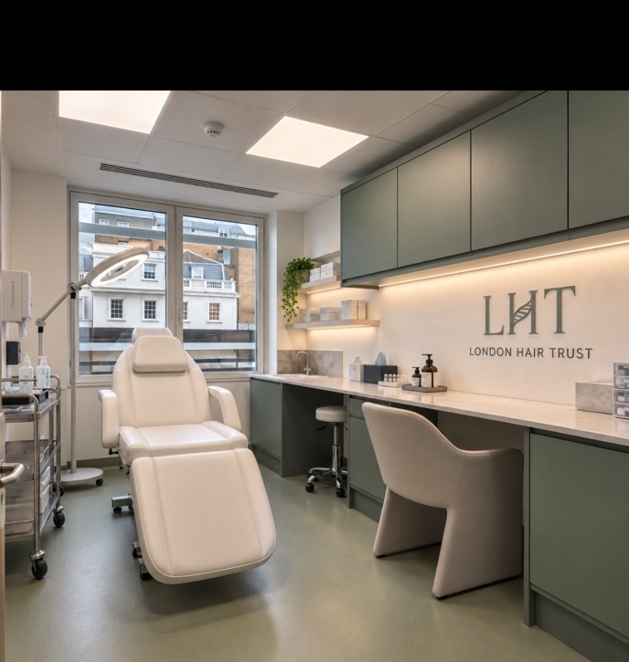 LHT treatment room with the London Hair Trust wall logo